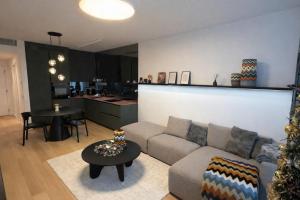 a living room with a couch and a table at Sky Park by MISSONI in Nivy