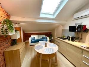 a small kitchen with a table in a small apartment at Capitole Hyper-centre, Mezzanine & confort in Toulouse