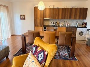 a living room with a dining table and a kitchen at Villa Rustica in Šišava