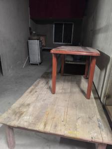 a wooden table sitting on top of a wooden floor at dormatery rooms in Jāmb