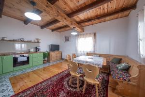 a kitchen with a table and chairs in a room at Casa Vlădușca in Peştera