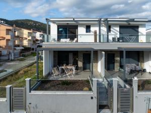 an aerial view of a house with a balcony at Aegean Grace Villa in Iraklitsa