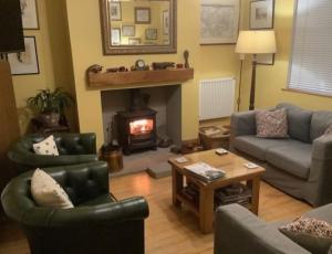 a living room with a couch and a fireplace at The Old Posthouse B&B in Caenby +51 photos
