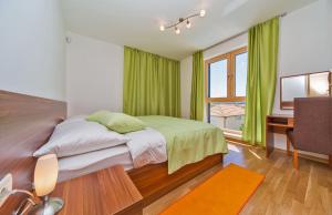 a bedroom with a bed with green curtains and a desk at Villa Slano in Slano +51 photos