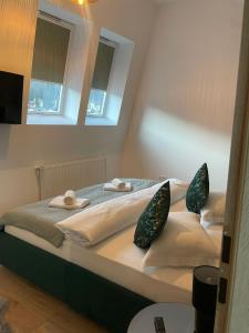a bedroom with a bed with two pillows on it at Marova Luxury Loft Caraiman View in Buşteni