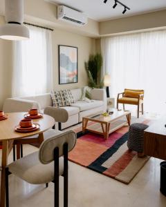 a living room with a couch and a table at Villette Serviced Apartments in Sodic New Cairo in New cairo