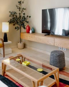 a living room with a tv and a coffee table at Villette Serviced Apartments in Sodic New Cairo in New cairo