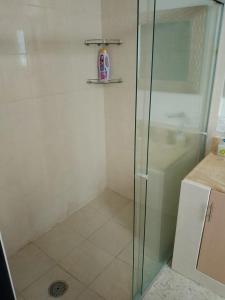 a shower with a glass door in a bathroom at Hotel Mi Casa Mata II in Morelia