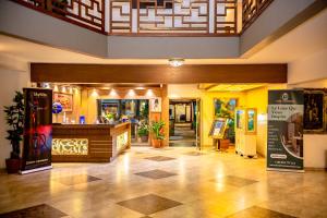 a lobby of a building with a store at Hotel Lubumbashi in Lubumbashi +133 photos