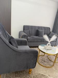 a living room with a couch and a table at The Nirvana Place in Nairobi