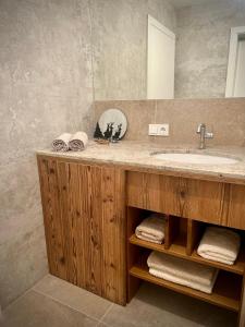 a bathroom with a sink and a mirror at SeeChalet Hallstatt in Bad Goisern +42 photos