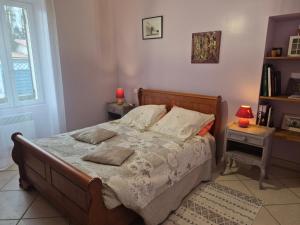 a bedroom with a bed with two tables and a window at Le gite du gueurlet in Boresse-et-Martron +25 photos