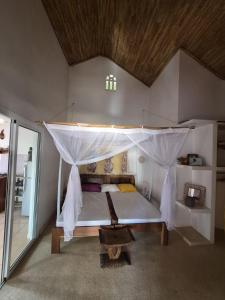 a bedroom with a bed with a canopy at keur MaÏ et Mao in Somone