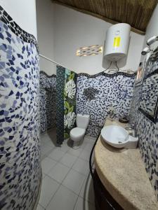 a bathroom with a sink and a toilet in it at keur MaÏ et Mao in Somone