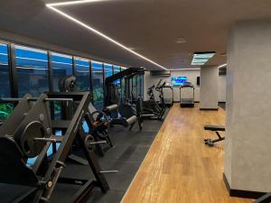 a gym with treadmills and cardio equipment in a building at Flat Hit Cabo Branco in João Pessoa