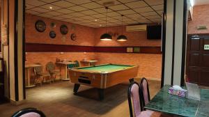 a room with a pool table in a restaurant at Hotel Summersands Al Wadi Al kabir in Muscat