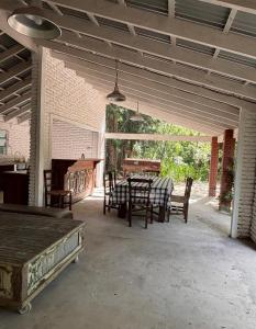 a patio with a table and chairs and a piano at Isla Chita in Tigre