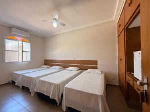 a bedroom with two beds and a ceiling fan at Hotel Nova Sorocabana in Brodósqui +31 photos