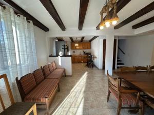 a living room with a table and chairs and a kitchen at Casa de vacanta Cabana Toto in Sebeşu de Jos