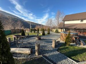 a garden with a picnic table and trees and a building at Casa de vacanta Cabana Toto in Sebeşu de Jos +12 photos
