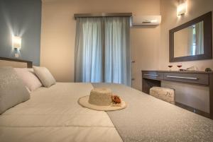 a hotel room with a bed with a hat on it at Reparo Studios in Lithakia