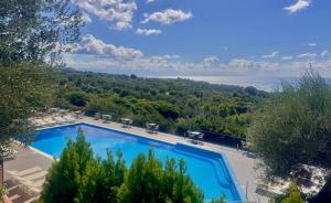 a swimming pool with a view of the ocean at Villaggio Turistico La Fenosa in Marina di Camerota