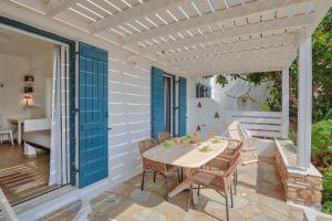 a patio with a table and chairs on a porch at Glaros Studios Apartments in Antiparos