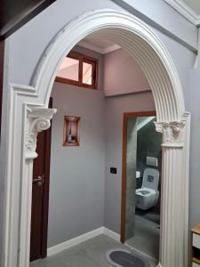 an archway in a bathroom with a toilet at Matilda apartment in Fier