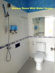 a bathroom with a shower room with a toilet at Nariska Suite Homestay in Yogyakarta