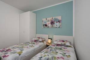 two beds sitting next to each other in a room at House Hana 2415 in Vodnjan +35 photos