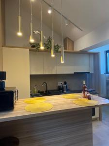 a kitchen with yellow placemats on a counter at Marova Luxury Loft Caraiman View in Buşteni +18 photos