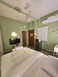 a hospital room with a bed and a projection screen at Green Zen Studio Metro 15 mins walk away in Dubai