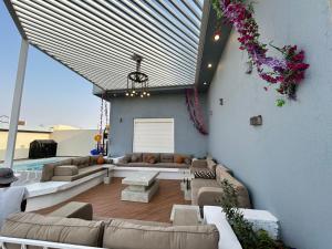 a living room with couches and a large window at IN 2 Chalet in Jeddah