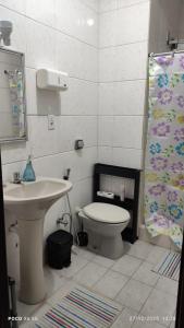 a bathroom with a sink and a toilet at House Duque de Caxias in Duque de Caxias +20 photos