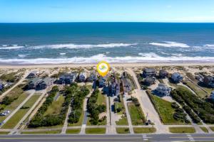 an aerial view of the beach with houses and the ocean at 7081 - Southern Breeze in Nags Head