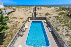 an overhead view of a swimming pool next to the beach at 7081 - Southern Breeze in Nags Head +82 photos