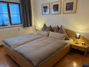 a large bed in a room with a window at Ferienwohnung Wohlesser in Annaberg im Lammertal