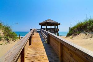 a wooden boardwalk leading to a gazebo on the beach at 1245 - Castle Sween in Corolla