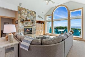 a living room with a couch and a fireplace at 1398 - Alotta Coladas in Corolla