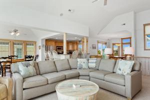 a living room with a couch and a table at 1398 - Alotta Coladas in Corolla