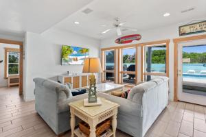 a living room with two couches and a table at 1398 - Alotta Coladas in Corolla +64 photos