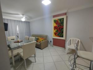 a living room with a table and a couch at Diamante guarapari in Guarapari