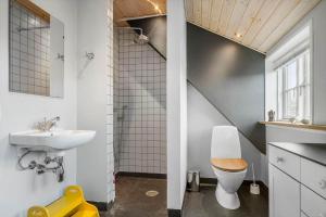 a bathroom with a sink and a toilet and a staircase at 20426-Samso-Nylandsvej-21 in Ballen +21 photos