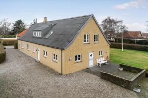 a large yellow house with a black roof at 20426-Samso-Nylandsvej-21 in Ballen