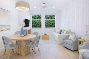 a living room with a table and a couch at Boutique condo w oceanfront & concierge in Palm Beach +29 photos