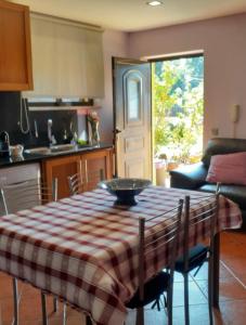 a kitchen with a table with a plaid table cloth at Casa Afonso in Ventosa