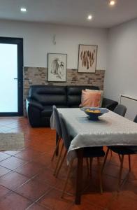 a living room with a table and a couch at Casa Afonso in Ventosa