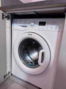 a white washing machine in a utility room at Riviera Begonia Appartement - Parking Privé in Roquebrune-Cap-Martin
