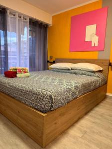 a bedroom with a large bed in a room at Riviera Begonia Appartement - Parking Privé in Roquebrune-Cap-Martin