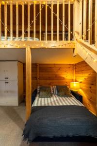 a bedroom with a bunk bed in a wooden cabin at Walliswood Lodge - Wood Burner, Air Con & Wi-fi, Rural Retreat in Ewhurst